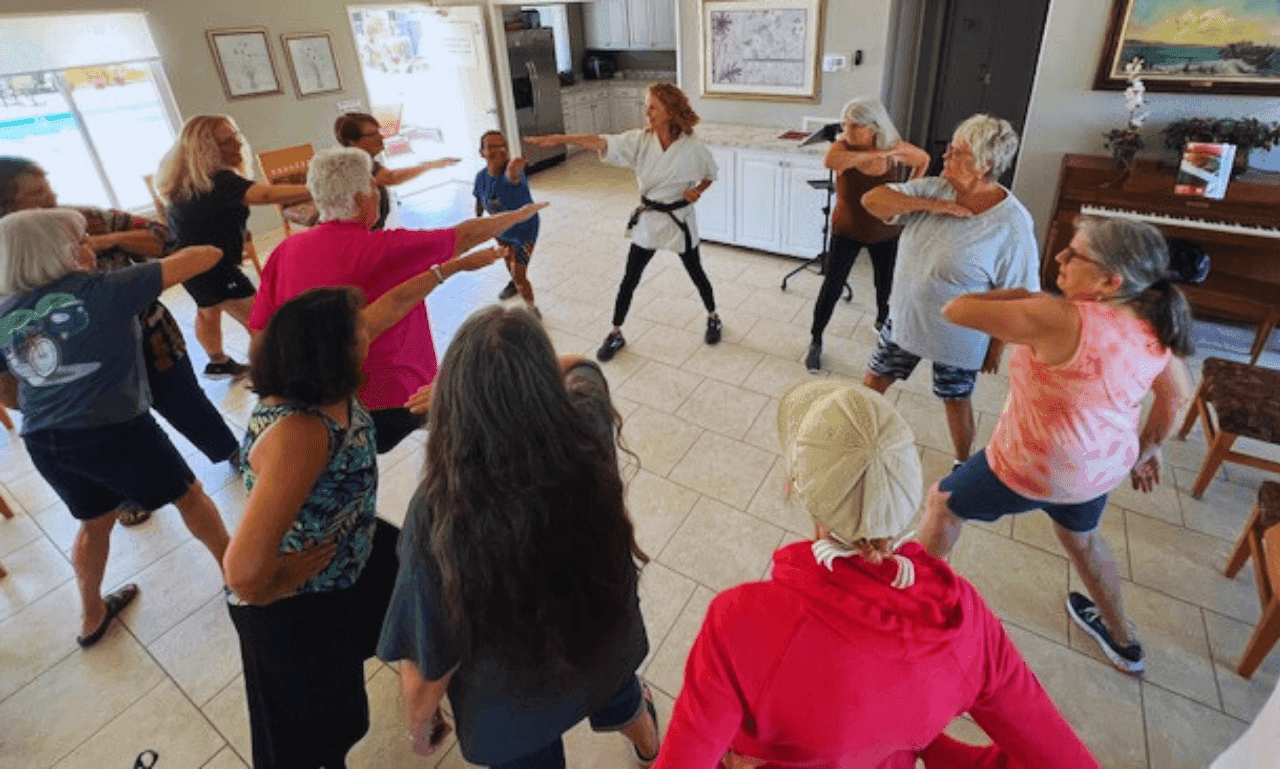 Cindy Baez leading a room of women through a self-defense strike